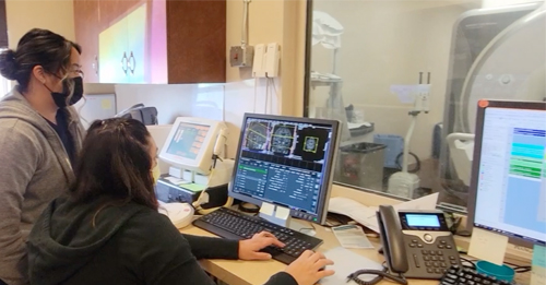 Two National Polytechnic College students looking at a medical imaging display as they learn about the trade.