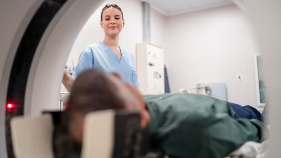 MRI technologist prepares to scan patient