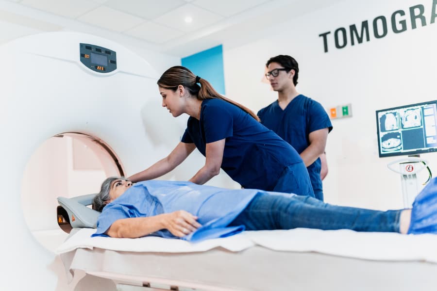 MRI technologists prepare patient for scanning