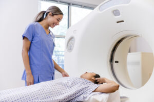 A patient talks to CT tech before going through CT scan machine