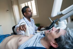 Doctor performing heart ultrasound on patient