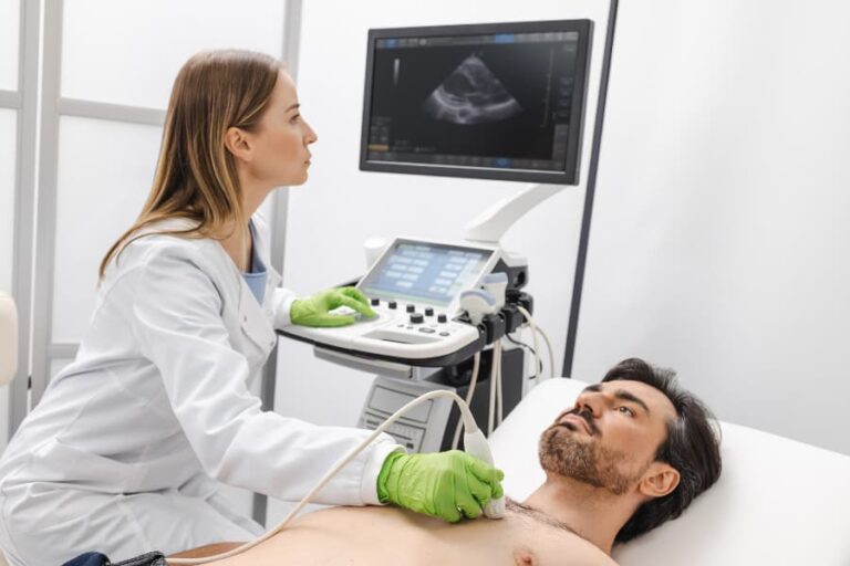Ultrasound specialist performing heart ultrasound exam on patient