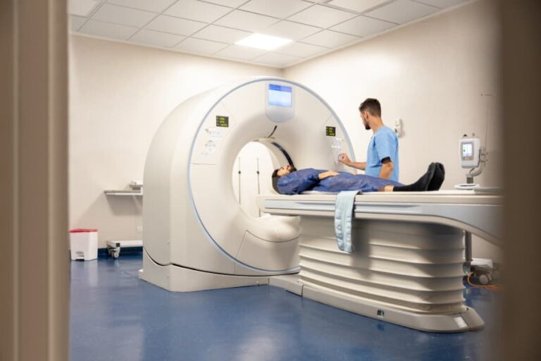 Technologist preparing patient for medical scan at hospital